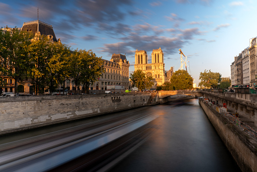 Low exposure photo of a boat on a canal on the Seine River in the old area of the capital of France. Paris. France. August 6, 2023