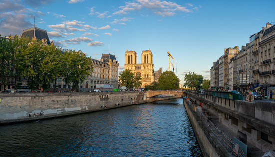 Photo of a canal of the Seine River in the old part of the capital of France with the Notre Dame Cathedral in the background. Paris. France. August 6, 2023