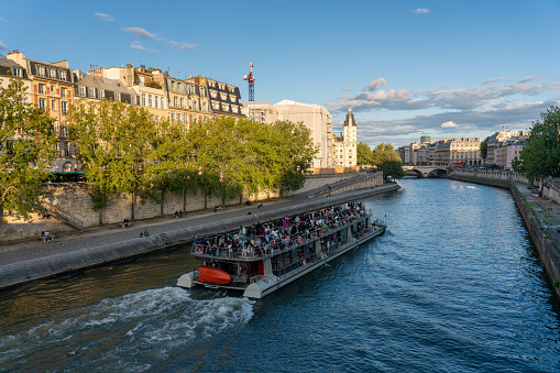 Tour boat on a canal of the Seine River in the old area of the French capital. Paris. France. August 6, 2023.