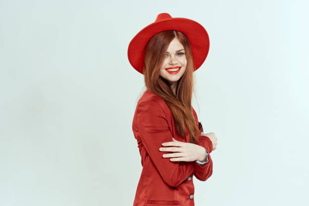 istock beautiful woman in red hat blazer makeup elegant style light background studio 2136518636