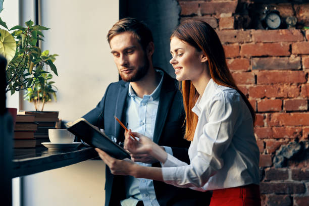istock a man and a woman are sitting at a table in a cafe work communication professionals 2136537283