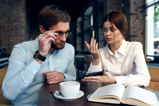 istock Business couple sitting at a table in a cafe breakfast communication work 2136545173