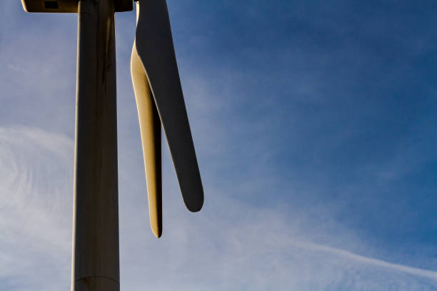 Wind Turbine with two blades showing. Blue sky background and wispy clouds.  Southern Alberta near Magrath