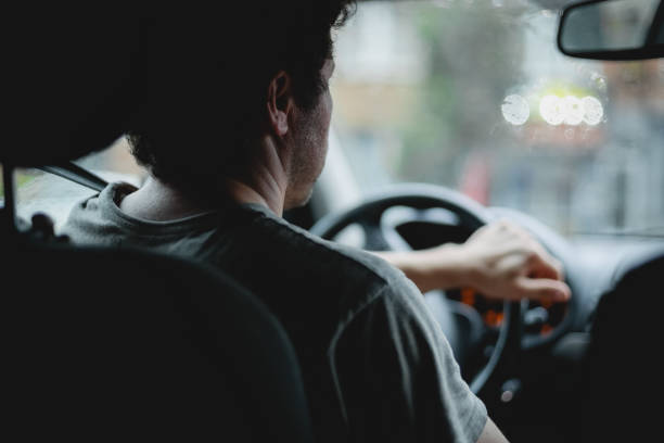 istock A young caucasian guy keeps his hand on the steering wheel while driving a car. 2136580363