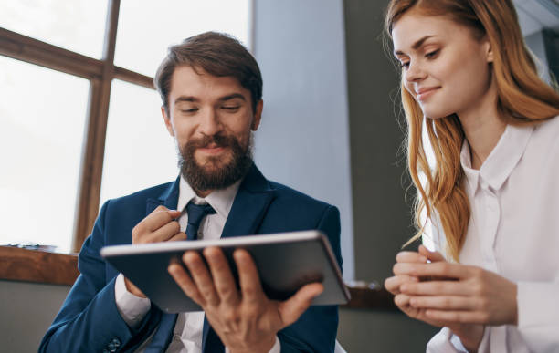 istock business man and woman tablet technology communication professionals 2136582966