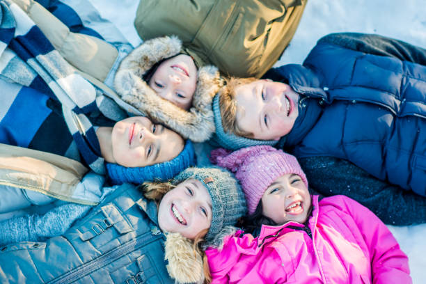 istock Children in the Snow Portrait 2136635333