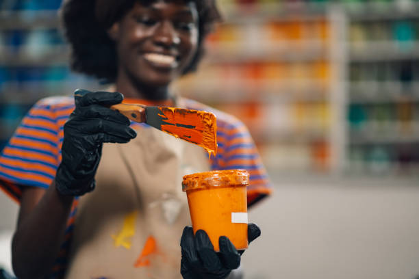 istock Interracial printing shop worker mixing paint for silk screen printing 2136635341