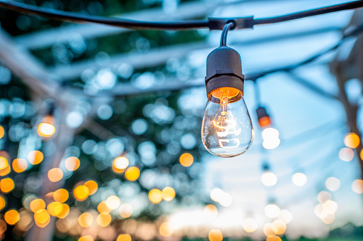 String lights hanging from an outdoor patio at a BBQ.