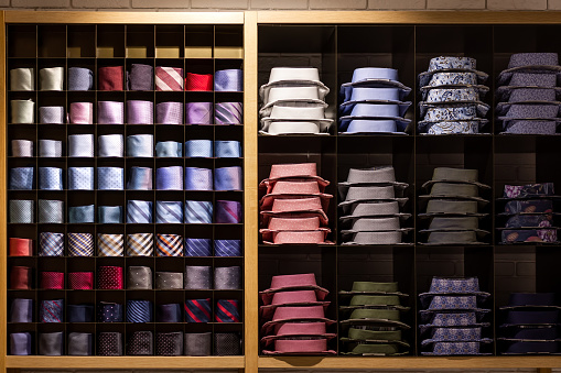 Brightly decorated showcase with men's shirts and a tie.