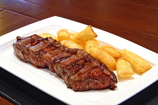 Strip Steak, classic cut of meat served on a plate