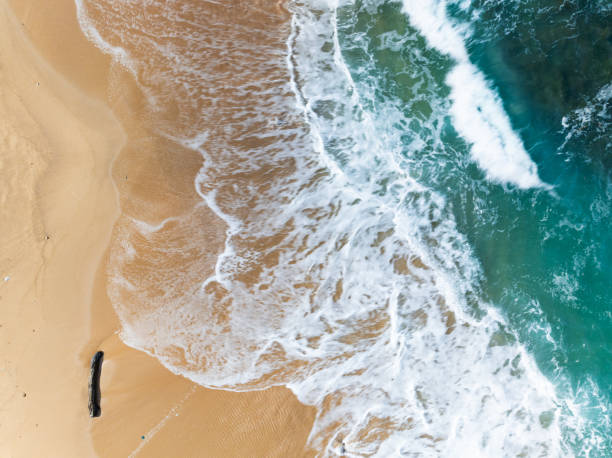 istock Top view beach with waves crashing on sandy shore,Beautiful waves sea surface in summer seascape background,Amazing beach colorful water background 2136724197