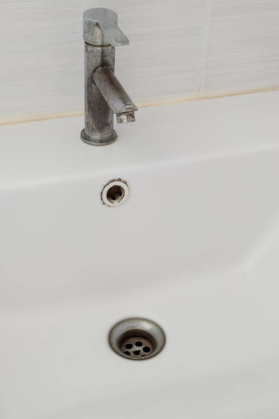 istock The ceramic sink basin with the stained faucet. 2136742070
