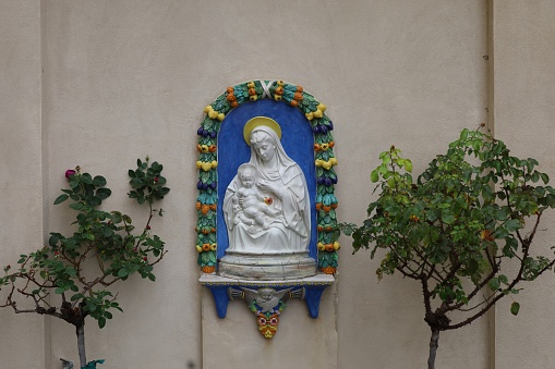 Statue of Virgin Mary and Jesus Christ holding different crucifixes