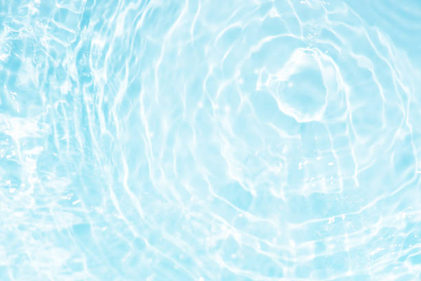 istock Bluewater waves on the surface ripples blurred. Defocus blurred transparent blue colored clear calm water surface texture with splash and bubbles. Water waves with shining pattern texture background. 2136782930