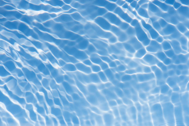 istock Bluewater waves on the surface ripples blurred. Defocus blurred transparent blue colored clear calm water surface texture with splash and bubbles. Water waves with shining pattern texture background. 2136783101