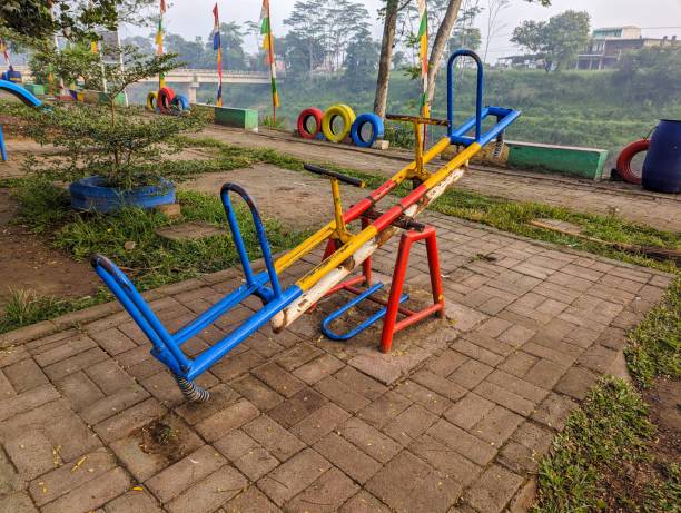 A game object, seesaw, with multi colors, in a city park, stock photo.
