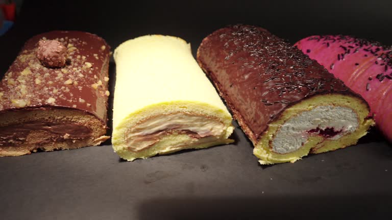 top view flat shot of slider shot of cake rolls brazo gitano swiss roll desserts collection chocolate ferrero cheese butter jelly berries cherry with black background