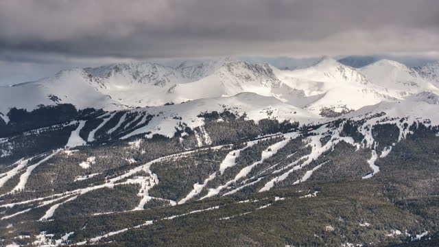 Vail pass i70 perspective of Copper Mountain ski resort trail runs Breck ten mile range Leadville Colorado epic ikon Rocky snowy winter spring snow field peaks late afternoon clouds pan reveal forward