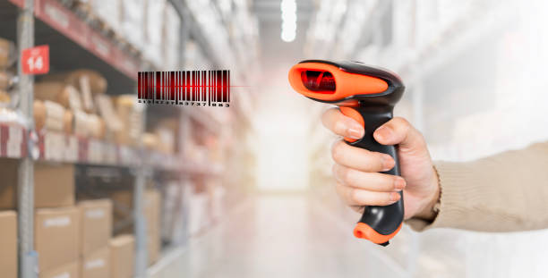 istock A person is holding a barcode scanner in a warehouse. A person is holding a barcode scanner and the barcode is red. 2136874520