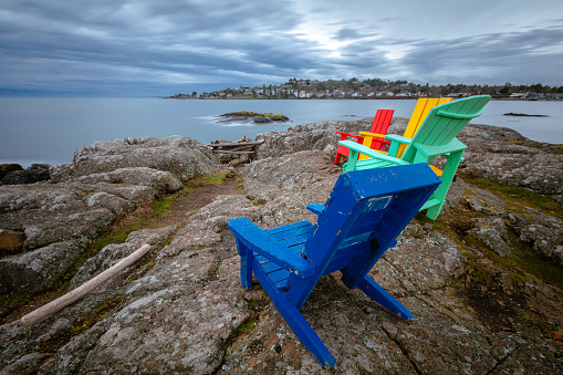 Colorful chairs along the rocky coastline of southern Vancouver Island.
