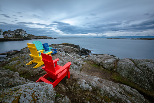 Colorful chairs along the rocky coastline of southern Vancouver Island.