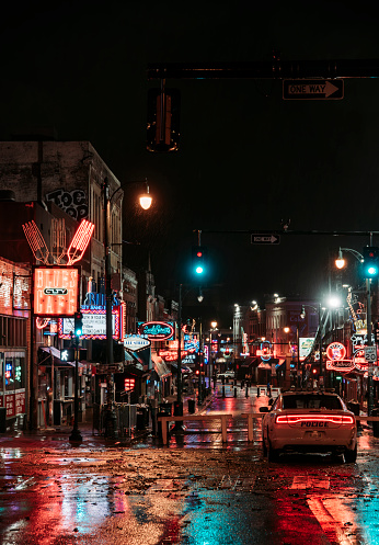 Police stationed at the top of Beale Street, which is completely empty during a heavy rainstorm in April 2023. Memphis, Tennessee, USA.