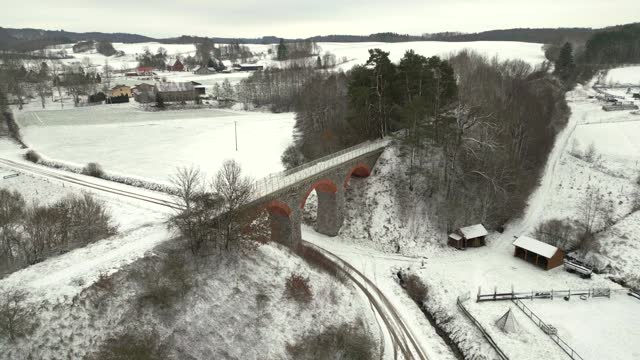Aerial view from a drone of a historic railway viaduct in a winter setting