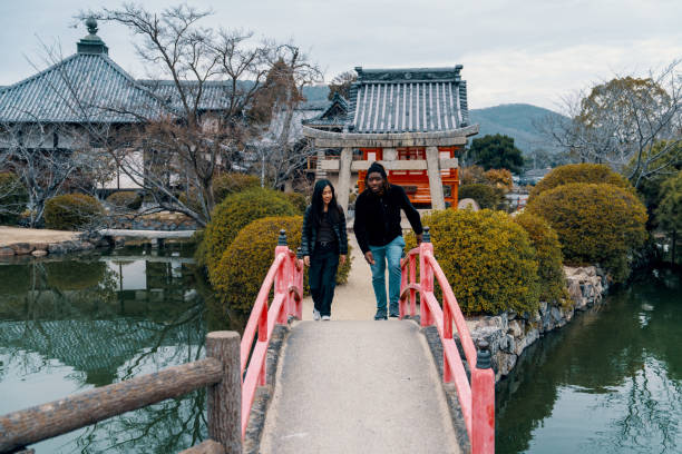 Two tourists visiting a shrine in Japan while on vacation