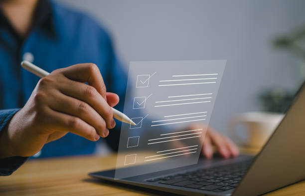 istock Business performance checklist concept, filling out digital form checklist. Businessman using laptop doing online checklist survey. 2136929090