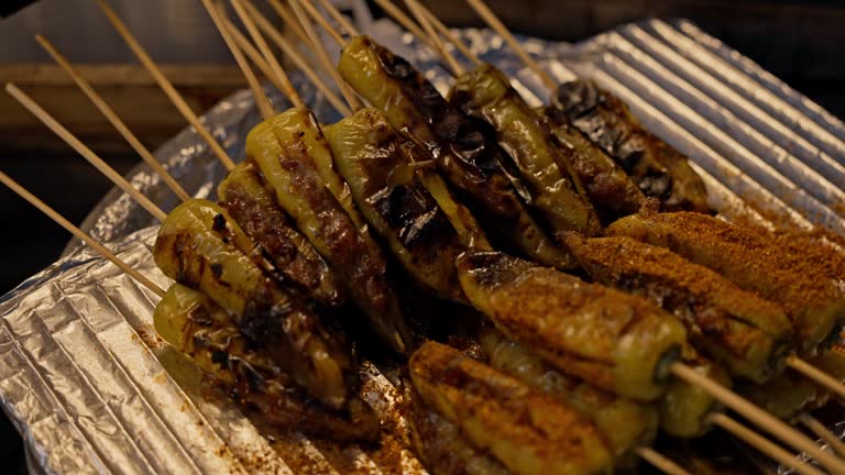 Local Asian Street Food: Traditional Thai BBQ Sausages and Meatball at Night Market