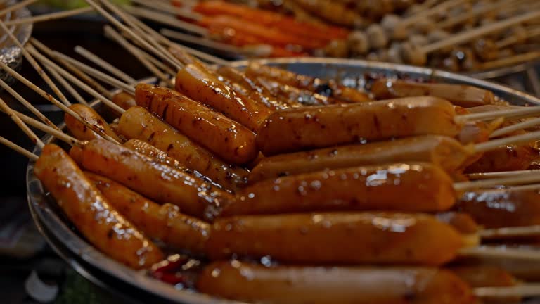 Local Asian Street Food: Traditional Thai BBQ Sausages and Meatball at Night Market