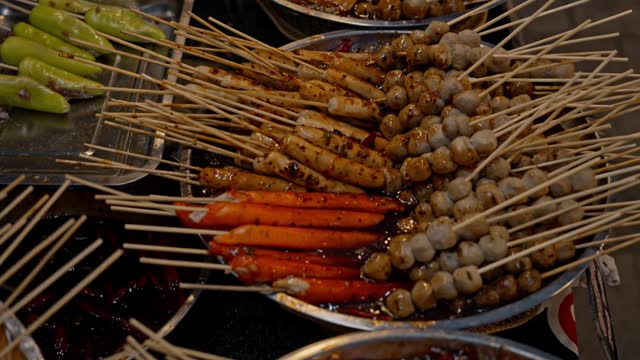 Local Asian Street Food: Traditional Thai BBQ Sausages and Meatball at Night Market