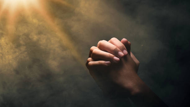 istock Christian man praying with raised hands 2136972164