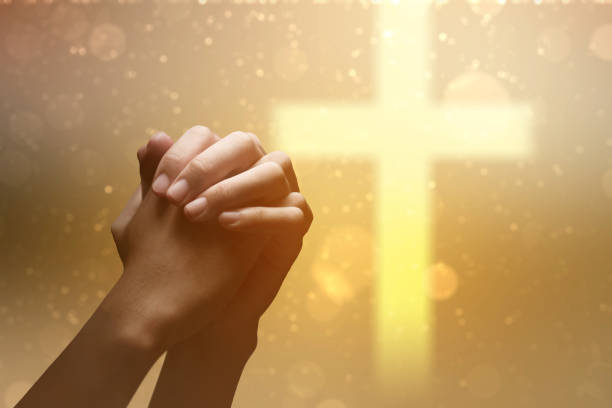 istock Christian man praying with raised hands 2136979473