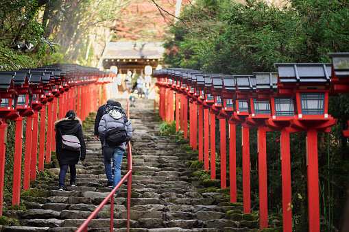 People are walking up the stairs to the Kifune shrine in Kyoto, Japan.