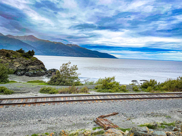Train tracks run alongside the Turnagain Arm in Alaska near Anchorage