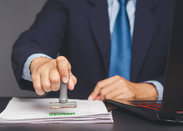 istock Businessman stamped for approved documents while sitting at a desk in the office. 2137026614