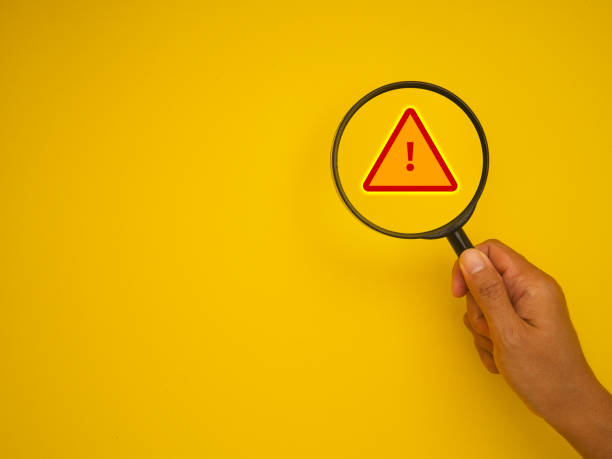 istock Warning sign magnified by magnifying glass. 2137027133