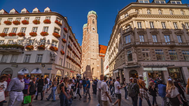 4K Time lapse of Crowd of People tourist walking and sightseeing attraction at Marienplatz a central square in the city centre of Munich and New Town Hall in summer, Munich, Bavaria, Germany