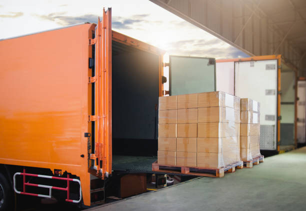 istock Package Boxes Stacked on Pallets Loading into Container Truck. Distribution Warehouse Shipping, Supply Chain Supplies, Shipment. Freight Truck Logistics Transport. 2137041571