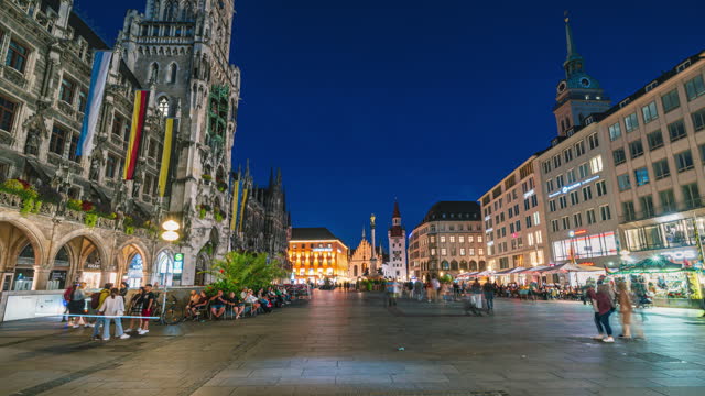 4K Footage Day to Night Time lapse of Crowd of People tourist walking and sightseeing attraction at Marienplatz a central square in the city centre of Munich and New Town Hall, Munich, Bavaria,Germany