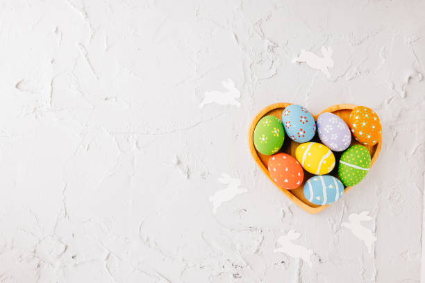 istock Top view easter eggs in shape heart isolated on white cement background 2137056781