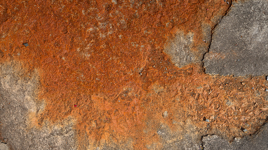 Cement floor with rustic iron color that damage on the surface due to acid or chemical spill and corrosive reactive on it. Background and texture.