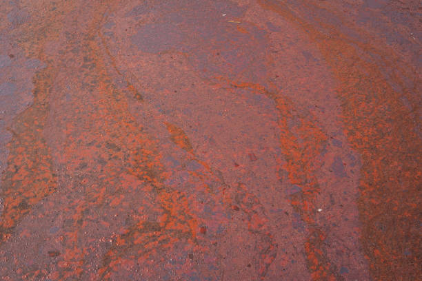 Dirty crude oil is splash on liquid surface due to oil spill to the environment accident. Background and texture, close-up and selective focus.