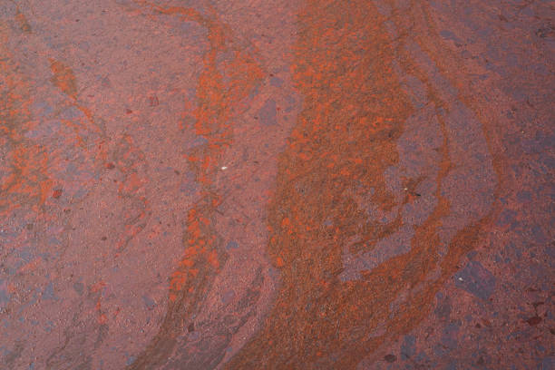Dirty crude oil is splash on liquid surface due to oil spill to the environment accident. Background and texture, close-up and selective focus.