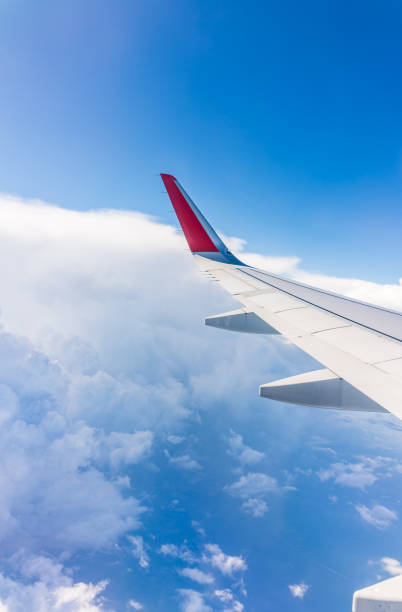istock View from the airplane window at a beautiful cloudy sky and the airplane wing 2137062986