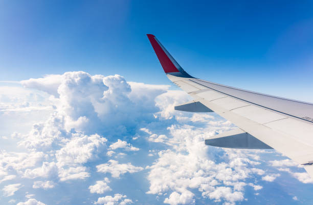 istock View from the airplane window at a beautiful cloudy sky and the airplane wing 2137062995