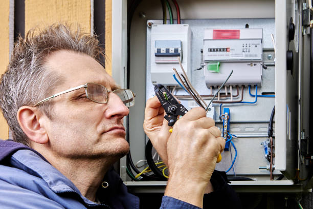 istock An electrician strips insulation from wire of three-phase power cable before connecting it to circuit breaker in an outdoor electrical panel. 2137098212