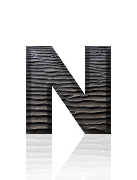 Close-up of three-dimensional mud flat pattern alphabet letter N on white background.