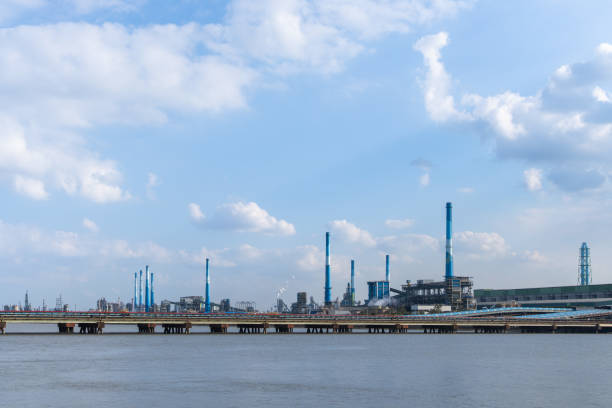 istock A factory with chimneys towering by the seaside with tall chimneys 2137187920